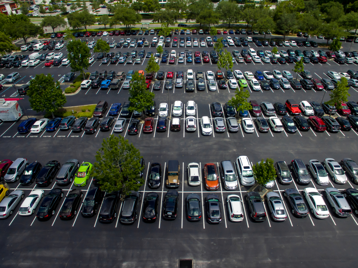 Aerial photo of cars parked in an office parking lot.