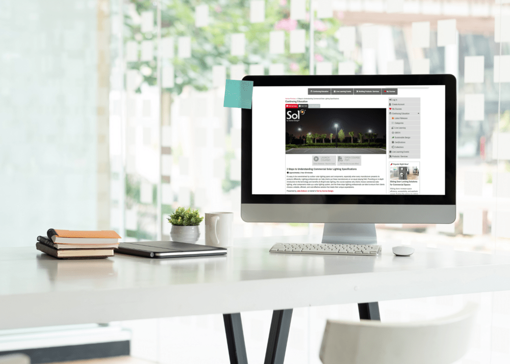 Desktop computer displaying Sol's 3 Steps to Understanding Commercial Solar Lighting Specifications on screen