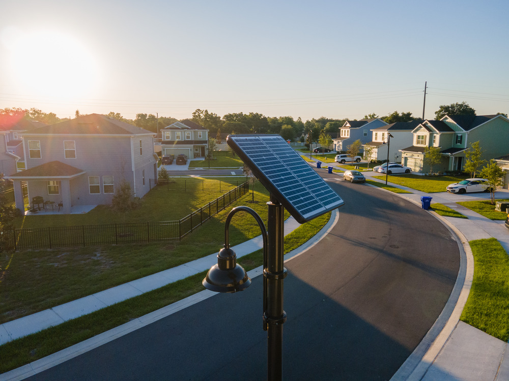 drone photography of Sol UP2 solar light on a quiet residential street with new homes in the background