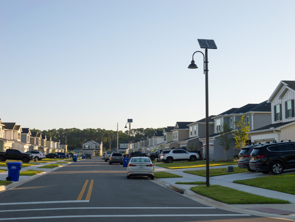 suburban street with houses and solar lighting