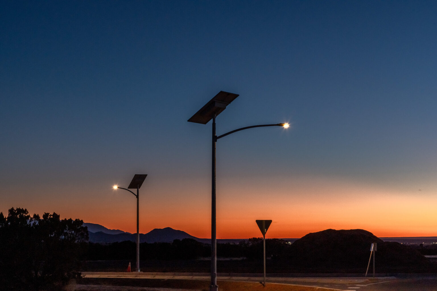 two solar lights against dark blue and orange sky in Santa Fe, New Mexico