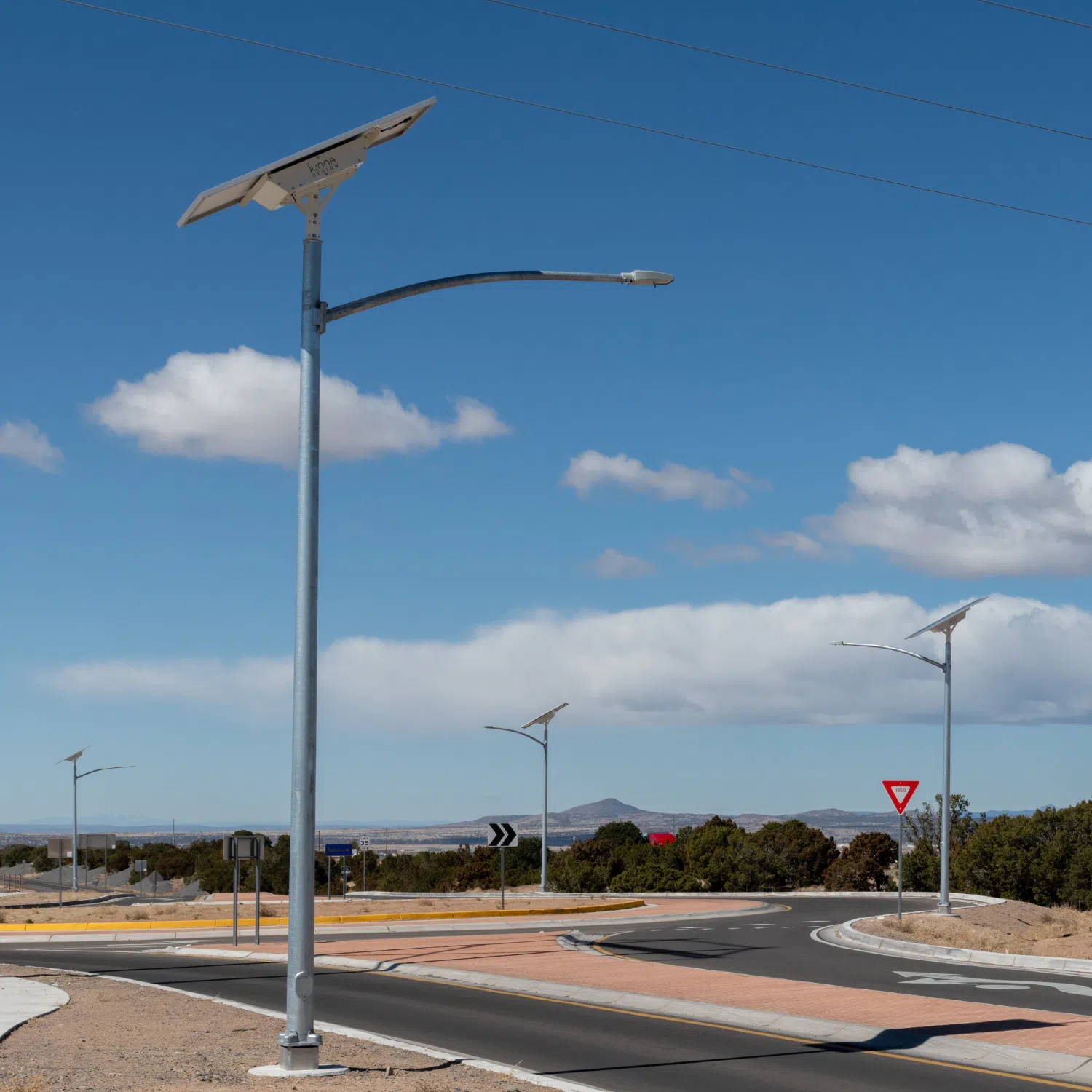EverGen solar street light at roundabout with brick and pavement and blue sky with clouds