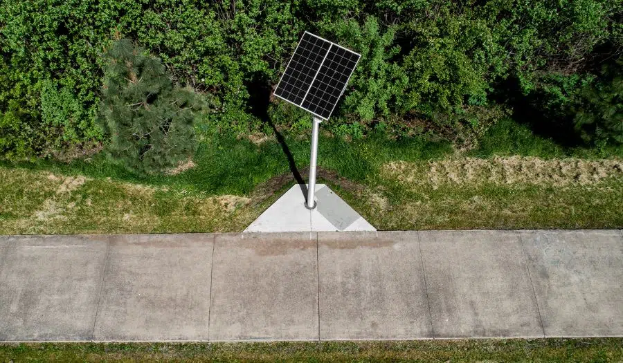 Aerial view of a solar light surrounded by sidewalk and grass