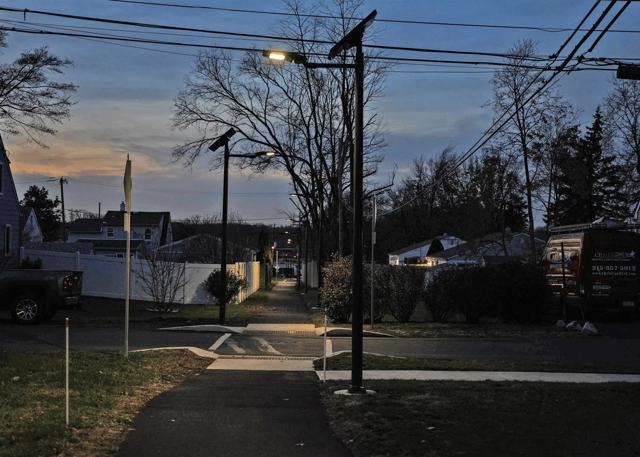 Two solar lights at dusk lighting up a crosswalk in Montgomery, Pennsylvania