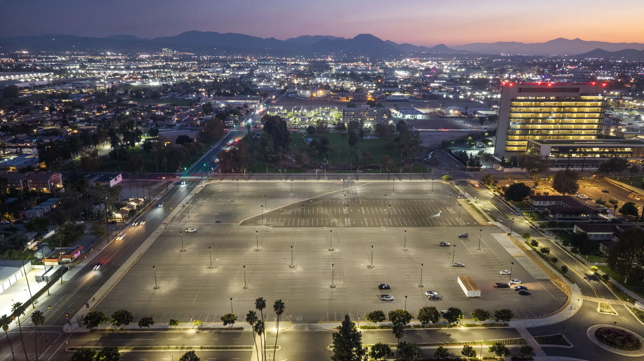 aerial image of parking lot illuminated with solar lights at dusk in san bernadino california