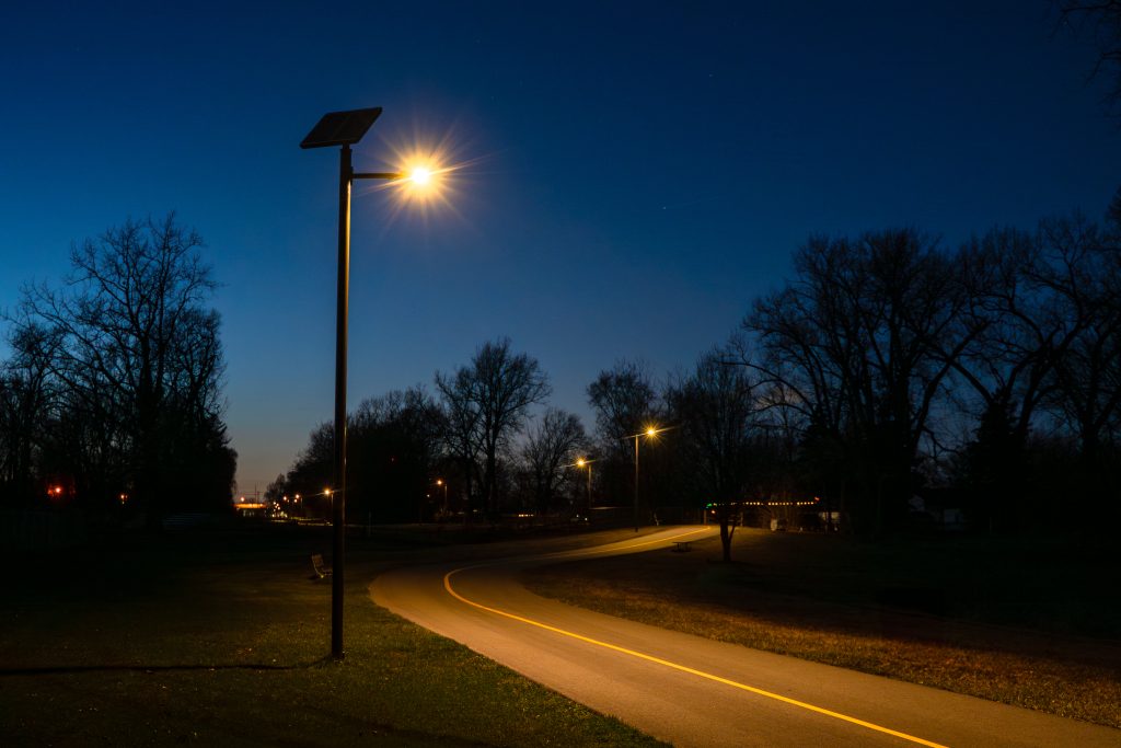 multi-use pathway at night with solar light illuminated and trees in the background
